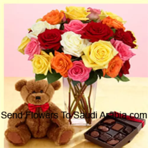 24 Mixed Colored Roses With Some Ferns In A Glass Vase, A Cute 12 Inches Tall Brown Teddy Bear And An Imported Box Of Chocolates
