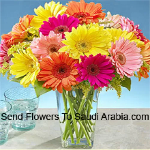 24 Mixed Colored Gerberas With Some Ferns In A Glass Vase