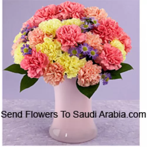 24 Mixed Colored Carnations With Seasonal Fillers In A Glass Vase